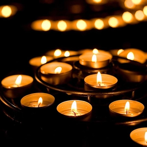 Smokeless white heart tea light candles in metal holders with a warm glowing flame