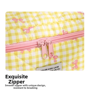 Detail of pink double-way zipper on yellow checkered quilted cotton cosmetic bag
