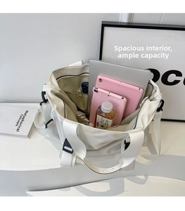 Spacious interior of white canvas tote bag showing storage capacity for a laptop