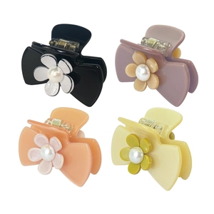 Set of four camellia flower hair claws with pearls in black, purple, orange, and cream