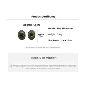 Detail view of vintage oval earrings with green rhinestones and silver needles