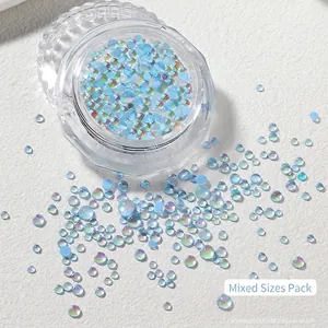 Macro shot of mixed size blue mermaid aurora glass nail art beads in a clear storage jar