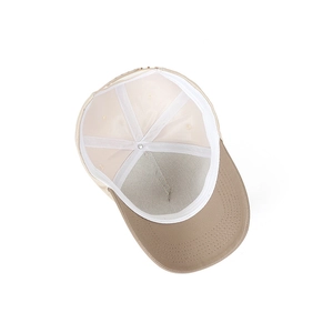 Detailed interior of color-block truck hat showing white sweatband and neat stitching