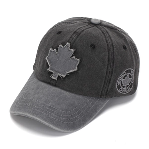 Detail of grey washed cotton baseball cap featuring embroidered maple leaf and Canada logo
