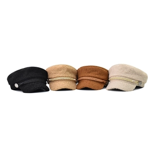 Flat lay of four stylish wool newsboy caps in black, khaki, caramel, and beige colors