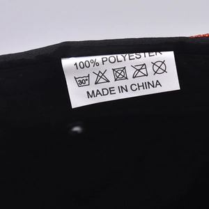 Macro shot of the 100% polyester fabric care label with washing symbols and made in China text