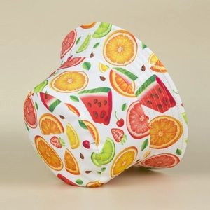 White bucket hat with colorful fruit prints shown from a side angle on neutral background