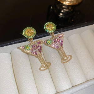 Detail of cocktail glass earrings with pearls, lime slice, and colorful crystals