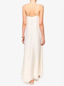 Elegant backless ivory long summer dress with thin straps and a flowing floor-length hemline