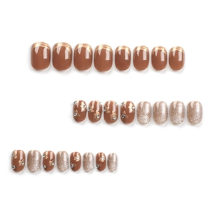 Short caramel brown press-on nails set with champagne gold glitter and floral accents