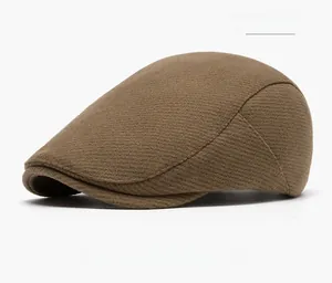 Macro detail of the coffee brown wool blend beret showing premium twill fabric texture