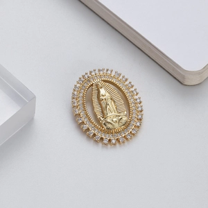 Detailed view of Virgin Mary pendant with gold finish and sparkling zircon stones