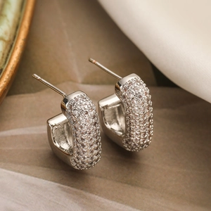 Silver geometric hoop earrings plated with sparkling cubic zirconia on soft fabric