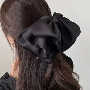 Elegant large black satin bow hair claw clip for women in a minimalist french style