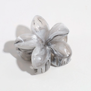 Detailed top view of marble textured flower hair claw clip with elegant ink pattern