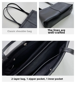 Detail view of the multi-compartment interior and stitched handles of the black tote bag