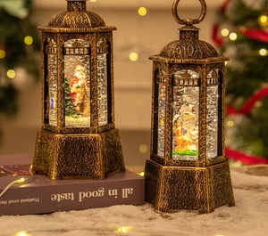 Detail of vintage Christmas snow lantern with Santa and Nativity scene inside a copper frame