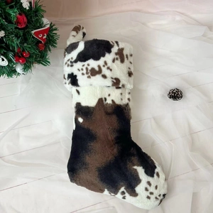 Close-up of fluffy cow print Christmas stocking with soft faux fur texture and hanging loop