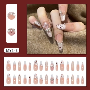 Pink cat eye press-on nails with heart crystals and pearls in long almond shape