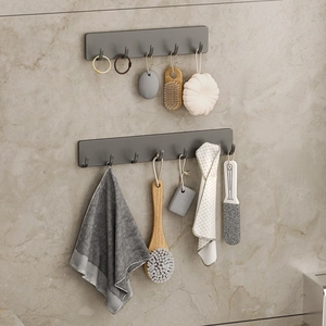 Matte grey kitchen and bathroom wall hooks mounted on marble tiles for storage