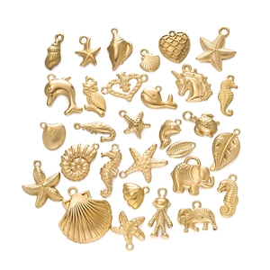 Macro shot of 25 gold plated stainless steel ocean theme charms for jewelry making