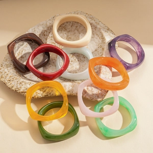 Colorful square resin bangles with marble texture in a retro minimalist geometric style