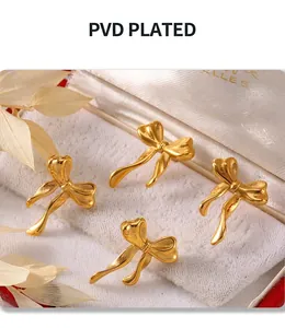 Macro shot of 4-piece bow knot stud earrings with polished PVD gold plating on white velvet