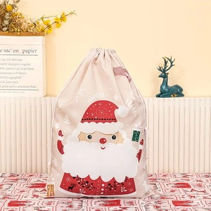 Canvas Santa Claus drawstring gift bag with festive holiday print on cozy home background