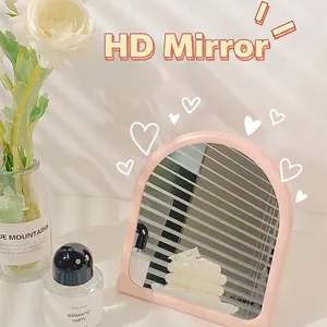Pink minimalist arched desktop makeup mirror with wavy aesthetic frame and matte finish