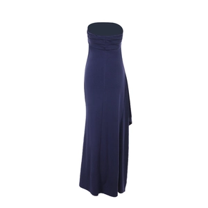 Detail view of navy blue tube knit dress featuring side ruching and split hem tailoring