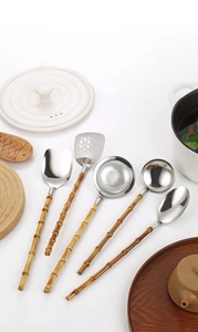 Detail of 304 stainless steel kitchen tool set with natural bamboo style handles