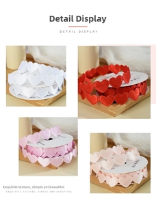 Macro detail of heart-shaped satin ribbons in white, red, and pink colors for gift wrapping