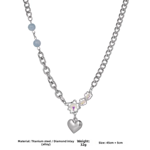 Close-up of heart pendant necklace with titanium steel chain and light blue beads