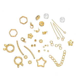 Detailed assortment of golden DIY jewelry findings including star and round metal spacers