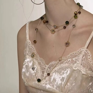 Three-layer gold necklace with colorful faceted beads and round ring accents for women