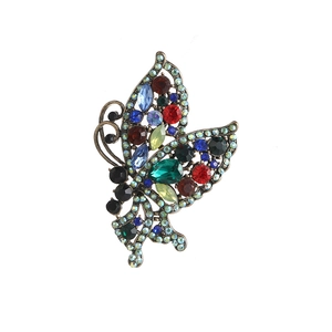 Vintage bronze butterfly brooch with multicolor crystals and intricate hollow wings