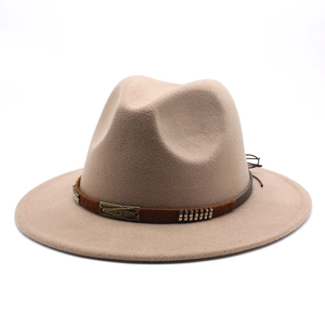 Detail of beige wool fedora hat featuring a brown fabric band with metal studs and plate