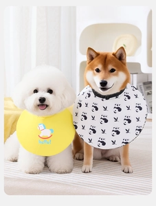 Detail of pet bibs featuring yellow cartoon horse and white panda prints on small dogs