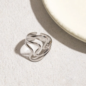 Close-up of silver multilayer wave textured adjustable stainless steel open ring