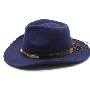 Close-up of the woven brown decorative band and texture on the navy wool felt cowboy hat