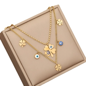 Double-layered gold stainless steel necklace with clover and evil eye pendant charms