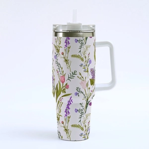 Detailed view of 40oz stainless steel tumbler with elegant floral pattern and straw