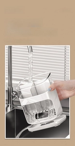 Detail of the detachable kitchen utensil holder showing easy cleaning under running water