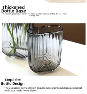Detail of grey ribbed glass vase showing thick steady base and modern U-shaped design