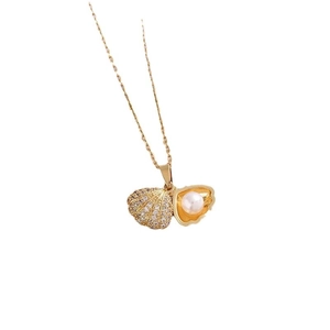 Golden shell pendant necklace with white pearl and sparkling cubic zirconia stones