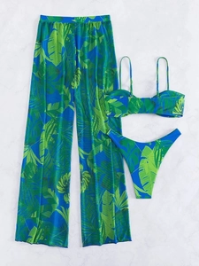 Flat lay of a three-piece tropical leaf bikini set with matching mesh wide-leg pants