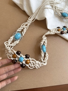 Detail of bohemian waist chain featuring blue turquoise stone and braided cotton rope