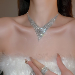 Macro shot of silver-colored V-shape fringe necklace with sparkling rhinestones details
