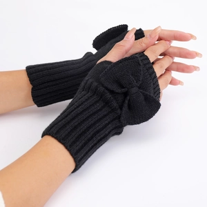 Detailed close-up of black knitted fingerless gloves with a decorative bow on white background