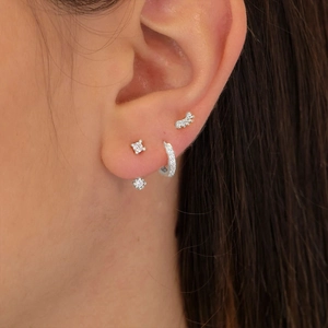 Close-up of S925 sterling silver evil eye stud earrings and hoop set with zircons